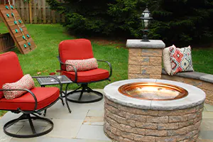 picture of a outdoor living space in the backyard using patio furniture, hardscaping patio pavers, fire pit, & more - DeMichele Inc Media, PA